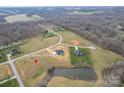 Expansive aerial view of a home's location on a sprawling, partially wooded lot, complete with a tranquil pond at 154 Carters Farm Dr, Statesville, NC 28625