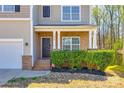 Charming home with a brick front porch and decorative shrubbery enhancing its curb appeal at 1929 Shorthorn St, Charlotte, NC 28213