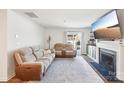 Inviting living room featuring comfortable seating, a fireplace, and a large-screen television for entertainment at 2027 Redstone Dr, York, SC 29745