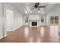 Bright living room featuring a fireplace, ceiling fan, and sliding glass doors to the back deck at 2390 Old Wilkesboro Rd, Statesville, NC 28625