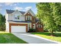 Beautiful two story home with brick and vinyl siding, attached two car garage, and well manicured lawn at 2514 Waters Vista Cir, Charlotte, NC 28213