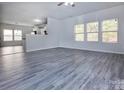 Spacious living room with modern gray wood flooring, bright lighting and an open floor plan at 3308 Lemongrass Ln, Charlotte, NC 28214