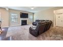Comfortable living room featuring plush seating, a cozy fireplace, and a large wall-mounted television at 4026 Clover Nw Rd, Concord, NC 28027
