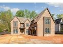Craftsman-style home with multi-paned windows and brick exterior awaiting landscaping at 412 Jefferson Dr, Charlotte, NC 28270