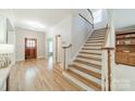 Inviting foyer with hardwood floors, staircase, and elegant details at 4599 Rustling Woods Dr, Denver, NC 28037