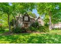 Beautiful brick home with lush, mature landscaping, creating a serene and inviting atmosphere at 4599 Rustling Woods Dr, Denver, NC 28037