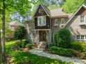 Charming brick home with a bay window, lush landscaping, and a well-manicured lawn at 4599 Rustling Woods Dr, Denver, NC 28037