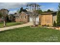 Exterior angle of a home with a garage, landscaping, and wooden fence at 5119 Blackberry Ln, Matthews, NC 28104