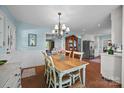 Inviting dining area with light blue walls, a rustic wooden table, and a view into the cozy living room at 5510 Sardis Rd, Charlotte, NC 28270