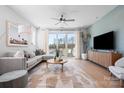 Spacious living room with neutral decor, a large sectional sofa, and access to an outdoor balcony at 5604 Kingspan Dr, Charlotte, NC 28217