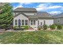 Spacious backyard featuring a dining set, lush lawn and multiple windows with ample sunlight at 7215 Meyer Rd, Fort Mill, SC 29715