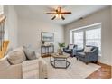 Cozy living room with hardwood floors, neutral furniture, and bright natural light from the window at 722 Sandy Green Ct, Fort Mill, SC 29715