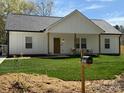 Charming home with a well-manicured lawn and inviting front porch with rocking chairs at 1022 Johnna Ln, Indian Land, SC 29707