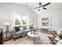 Bright living room features vaulted ceilings, neutral decor, modern furnishings, and large windows for ample natural light at 1026 Dooley Dr, Charlotte, NC 28227