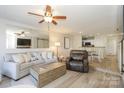 Open-concept living area featuring a dining area, a fireplace, and neutral decor at 104 Pier 33 Dr # 308, Mooresville, NC 28117