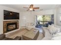 Bright living room featuring a stone fireplace, a ceiling fan, and access to a private balcony at 104 Pier 33 Dr # 308, Mooresville, NC 28117