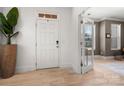 Bright foyer with light hardwood floors, a white front door, and open doorway at 10914 Zac Hill Rd, Davidson, NC 28036