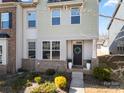 Inviting front entrance with a decorative wreath, potted plants, and a charming landscaped garden at 10914 Zac Hill Rd, Davidson, NC 28036
