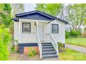 Charming cottage-style home with white siding, black trim, and inviting front porch at 110 Steele St # 34 35, Fort Mill, SC 29715