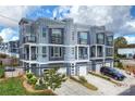 Eye-level view of a modern townhome neighborhood with neat lawns and ample parking on paved driveways at 1651 Duckworth Ave, Charlotte, NC 28208