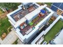 A rooftop patio with seating, dining space, and greenery, creating a private outdoor oasis at 1651 Duckworth Ave, Charlotte, NC 28208