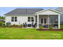Spacious backyard with a patio, fire pit, manicured lawn and screened-in porch at 2041 Mantle Ridge Dr, Indian Trail, NC 28079