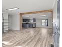 Open-concept living room featuring wood floors, modern lighting, and a view of the kitchen at 2154 Withers Dr, Maiden, NC 28650