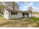 Single-story home with a two-car garage, comfortable front porch sitting area, and spacious yard at 217 Cedarhurst Ln, Clover, SC 29710