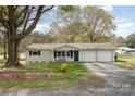 Cozy single-story home with a two-car garage, comfortable front porch sitting area, and yard at 217 Cedarhurst Ln, Clover, SC 29710