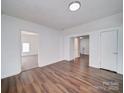 Bright, spacious room showcasing laminate flooring, fresh paint, and neutral colors at 2300 Kennesaw Dr, Charlotte, NC 28216