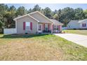 Cute house with red shutters, manicured lawn, and inviting front porch at 2401 Gelsinger Ave, Bessemer City, NC 28016