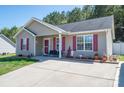 Inviting home with red shutters and a charming front porch with bench at 2401 Gelsinger Ave, Bessemer City, NC 28016