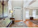 Bright foyer with hardwood floors, transom windows over the door, and elegant architectural details at 2740 Cameron Commons Way, Matthews, NC 28104