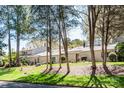 A view of the townhome community featuring lush lawn and mature trees on a sunny day at 3709 Willow Point Dr, Charlotte, NC 28277