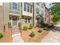 Beautiful townhouse exteriors with front yard landscaping and brick staircases to the front doors at 3718 Speer Blvd, Charlotte, NC 28217