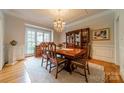 Traditional dining room featuring a wooden table set for eight, complemented by a decorative china cabinet and bright window at 4646 Eagle Pointe Ct, Denver, NC 28037