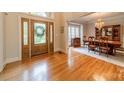 Spacious entryway features hardwood floors, decorative glass door, and access to the formal dining room at 4646 Eagle Pointe Ct, Denver, NC 28037