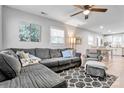 Cozy living room with sectional couch, ceiling fan and neutral colors at 501 S Inman Ave, Bessemer City, NC 28016