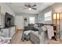 Inviting living area featuring a large sectional sofa, ceiling fan, and ample natural light at 501 S Inman Ave, Bessemer City, NC 28016