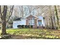 Inviting single-Gathering home with lush lawn, brick accents, attached garage, and mature trees at 5016 Haybridge Rd, Charlotte, NC 28269