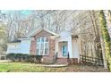 Attractive single-story home with brick details, an attached garage, and a quaint front porch at 5016 Haybridge Rd, Charlotte, NC 28269