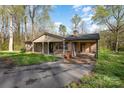 Inviting brick home featuring a covered front porch, attached carport, and convenient driveway access at 518 W Westview St, Gastonia, NC 28052