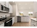 Modern kitchen featuring stainless steel appliances, granite countertops, and white cabinets at 5611 Skinny Down, Charlotte, NC 28215