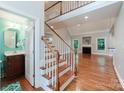 Spacious entryway with hardwood floors, staircase, and view into the living area at 6414 Winding Creek Ln, Denver, NC 28037