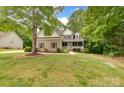 Attractive two-story home featuring a welcoming front porch and lush green lawn at 6414 Winding Creek Ln, Denver, NC 28037
