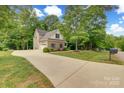 Inviting home with long driveway and mature trees at 6414 Winding Creek Ln, Denver, NC 28037