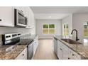 Well appointed kitchen with stainless appliances and granite counters at 7015 Jerimoth Dr, Charlotte, NC 28215