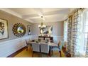 Elegant dining room with stylish decor, coffered ceilings, large window, and seating for six at 7016 Butternut Oak Ter, Huntersville, NC 28214