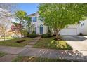 Charming two-story home with a well-manicured lawn, inviting walkway, and vibrant landscaping at 7262 April Mist Trl, Huntersville, NC 28078