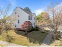 Charming two-story home with a well-manicured lawn, inviting walkway, and vibrant landscaping at 7262 April Mist Trl, Huntersville, NC 28078